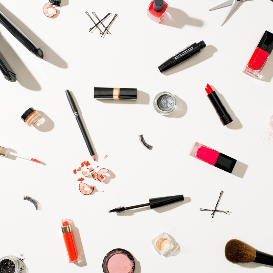 Flat lay of makeup and cosmetics on a neutral background