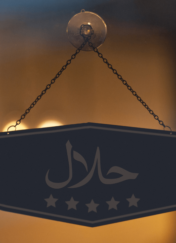 Halal sign in Arabic on a restaurant window