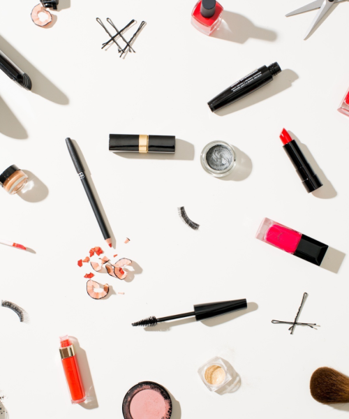 Flat lay of makeup and cosmetics on a neutral background