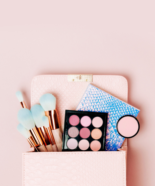 Flat lay top view of a makeup bag with beauty products