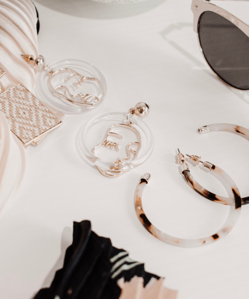 Various women fashion accessories on a neutral background